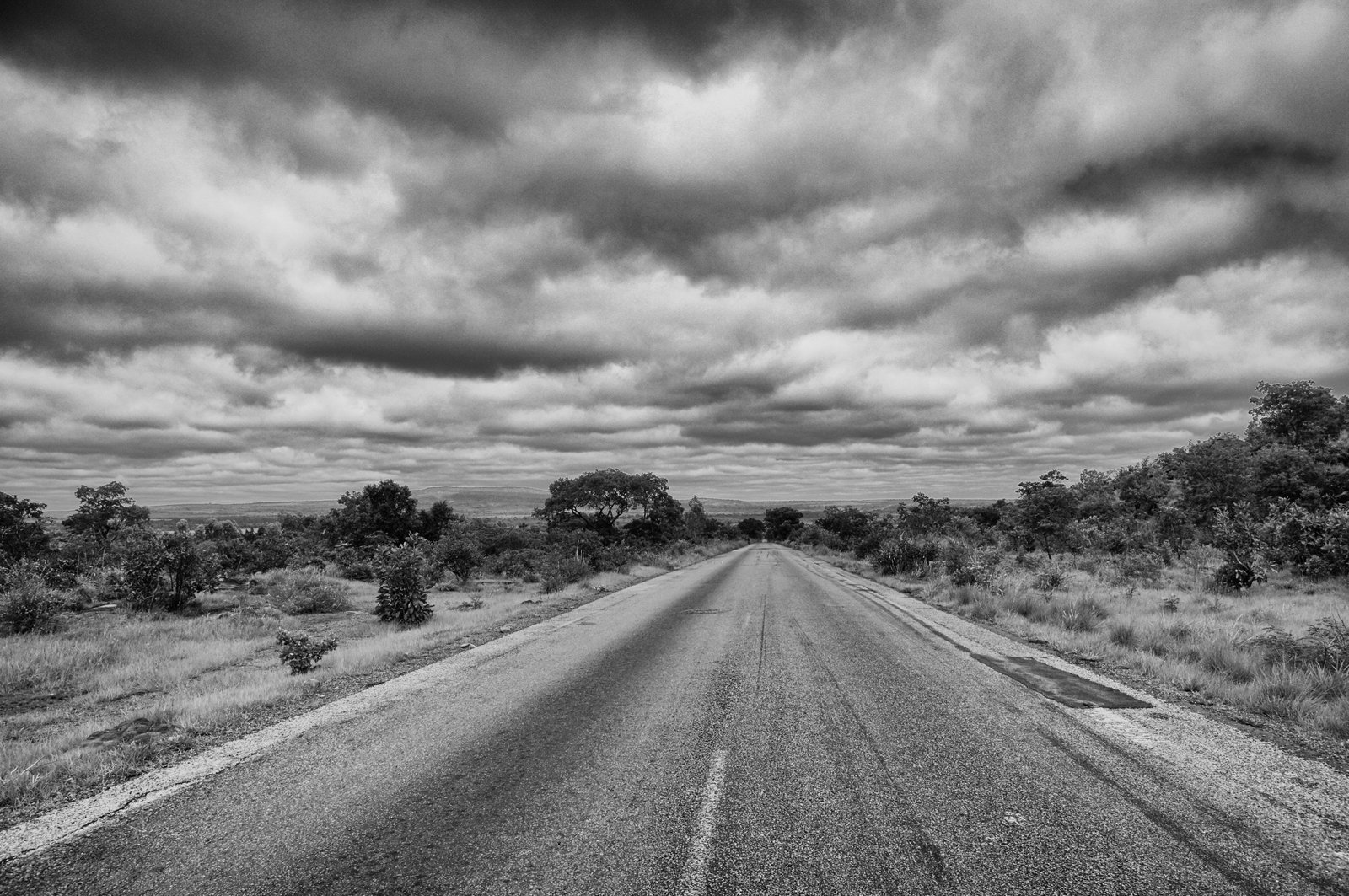 a black and white photo of an empty road