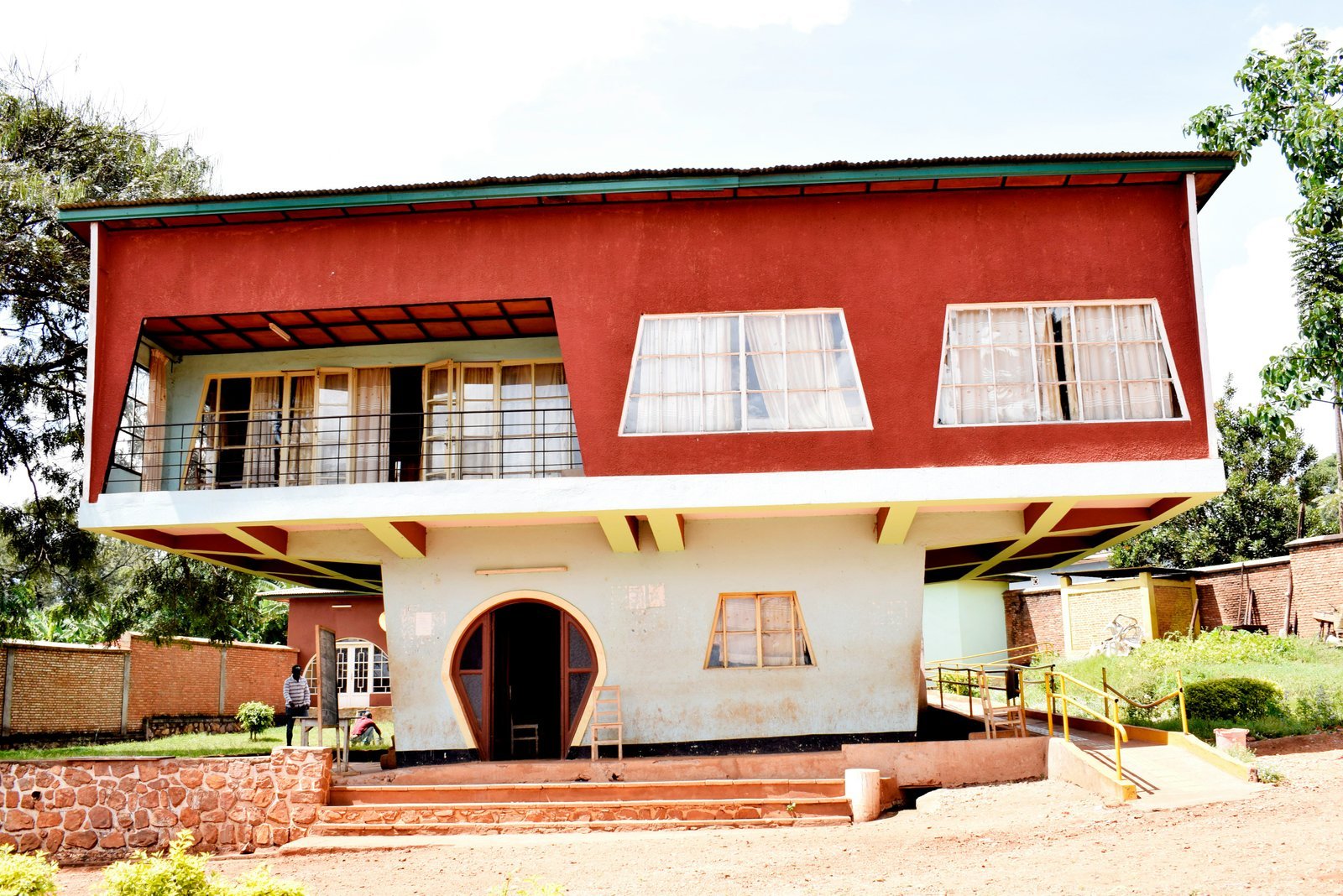 a red and white house with a balcony