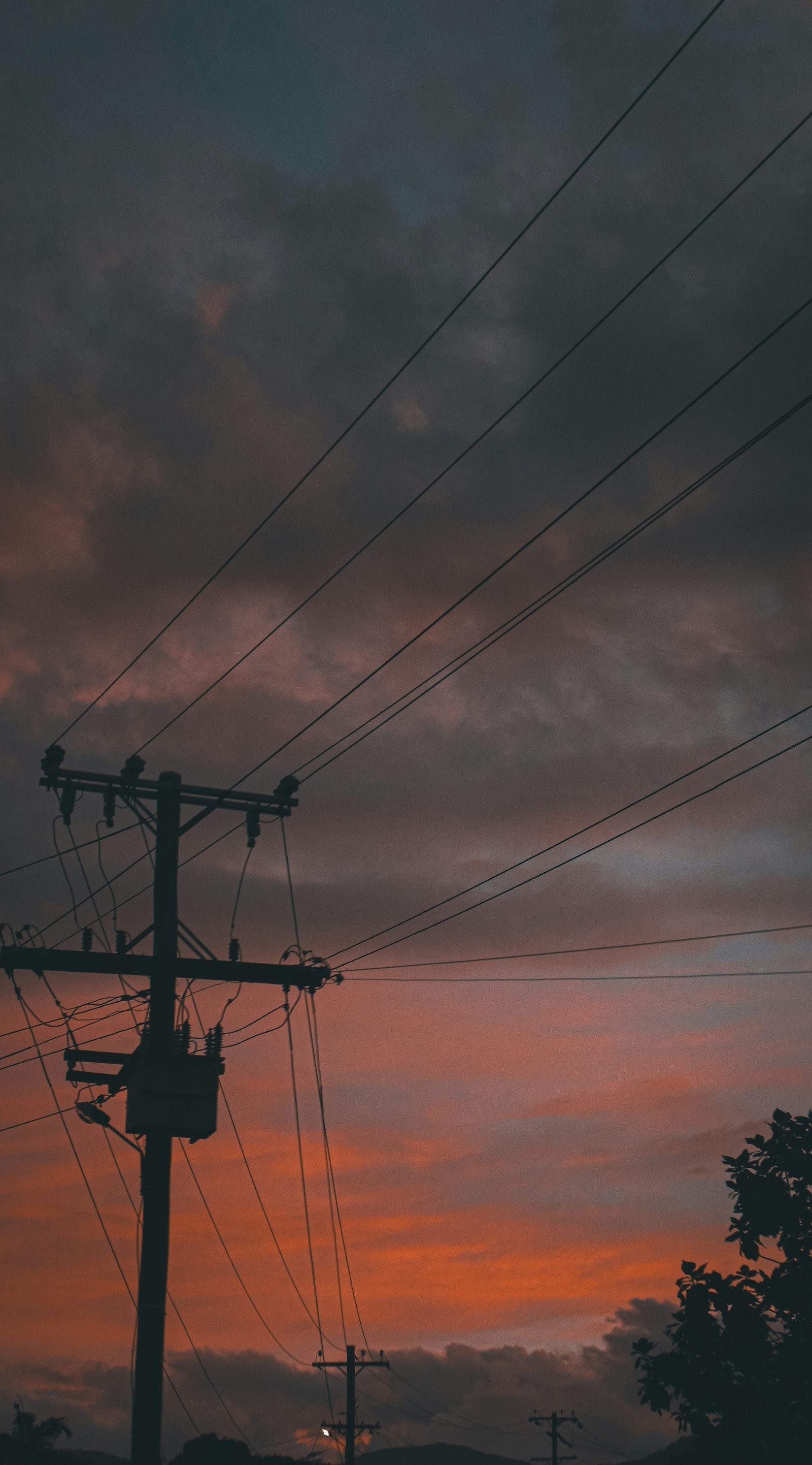 a telephone pole with a sky in the background