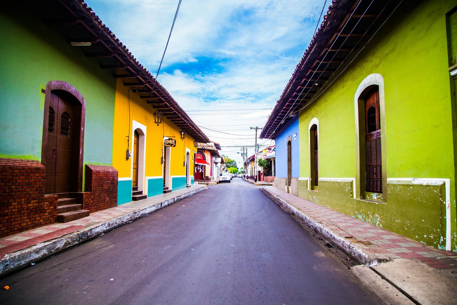 pathway of houses under blue clouds during daytime national anthem of nicaragua